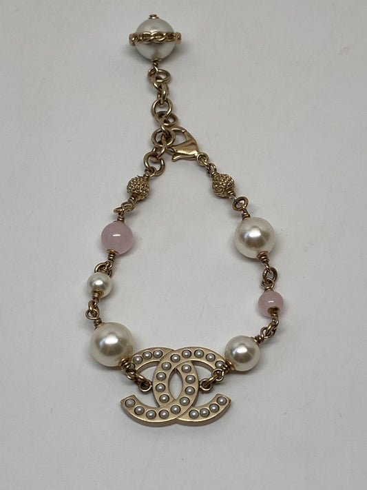 CHANEL GOLD TONE CC BRACELET WITH PEARLS